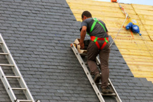 slate roofing company install working